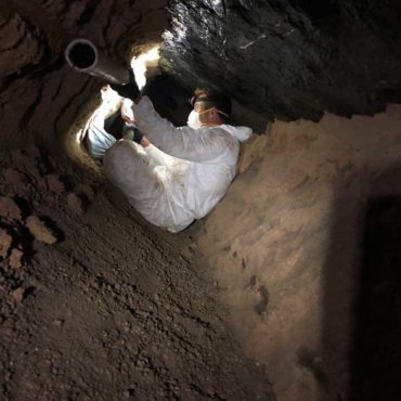 Professional Kinsey plumbers repairing a drain.