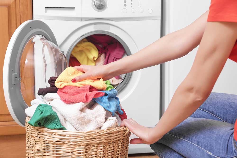 person taking laundry out of the washing machine